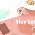 woman's hands writing goals, stop setting goals with these tips